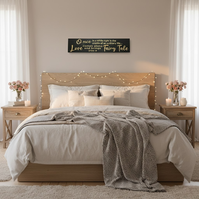 Bedroom wall décor featuring the “Once in a while love brings you a fairy tale” wooden sign above bed — romantic carved wall art handmade in Kentucky.