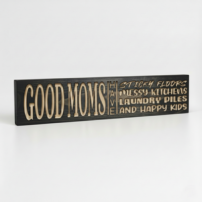 Perspective view of a handmade wooden wall sign for moms featuring deeply carved lettering and natural wood grain.