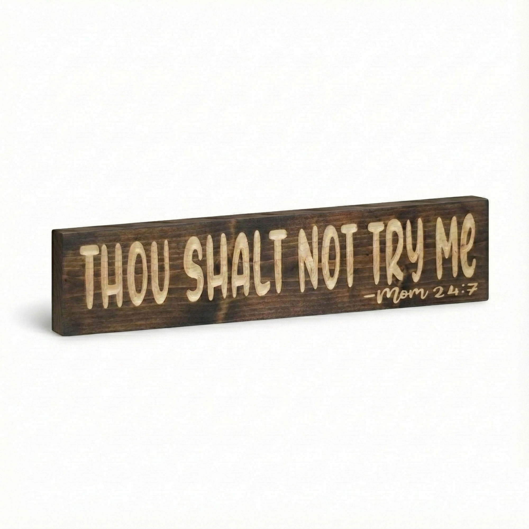 Isolated view of the rustic farmhouse style wooden sign saying "Thou Shalt Not Try Me - Mom 24:7" against a white background.
