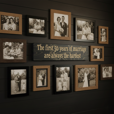 "Funny anniversary wood sign displayed as a centerpiece on a dark shiplap gallery wall surrounded by family wedding photos."