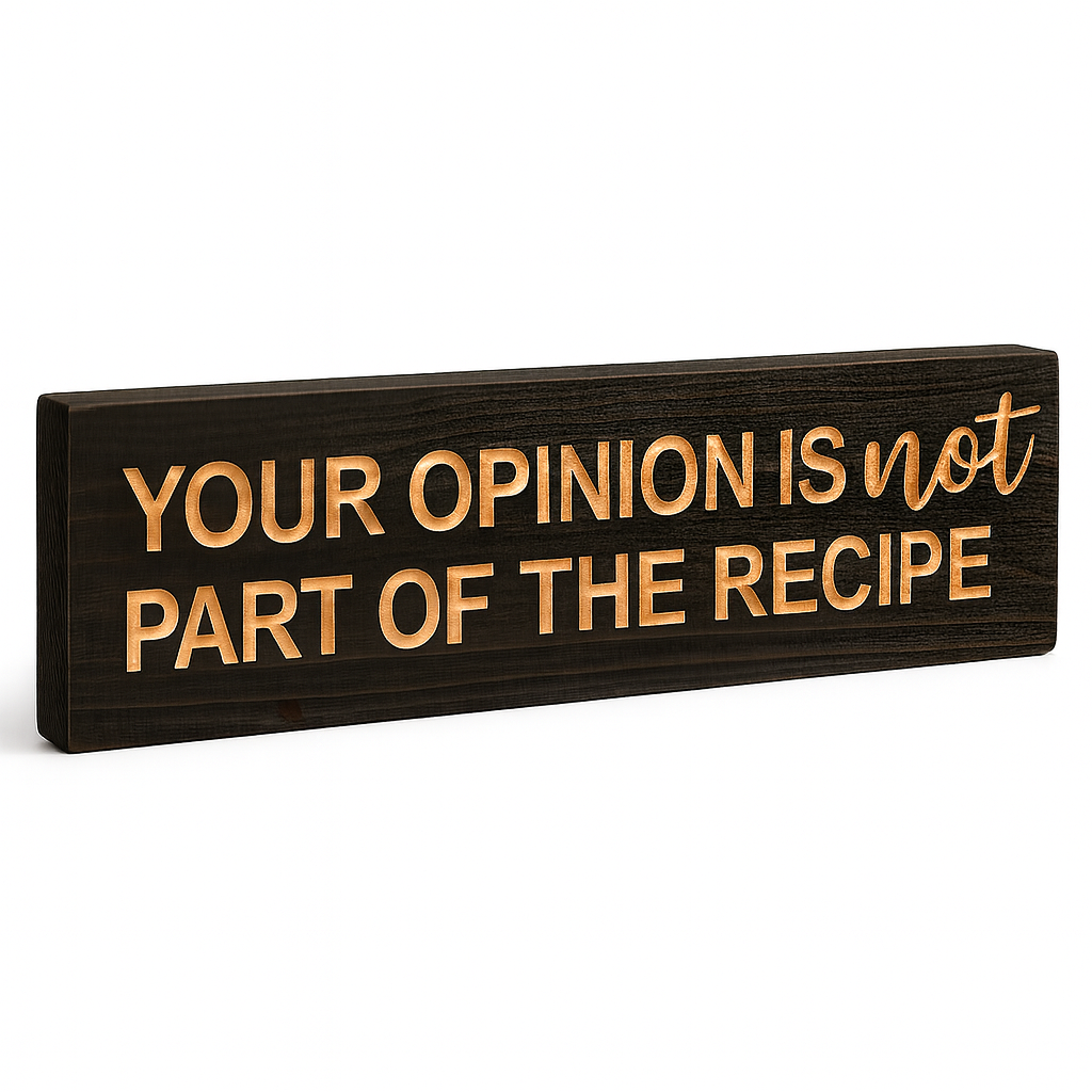 Angled view of carved rustic wooden kitchen sign with the quote “Your Opinion Is Not Part of the Recipe,” showing depth and wood grain.