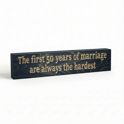 "Side view of a 0.75 inch thick solid wood anniversary plaque showing the depth of the CNC carving and natural grain."