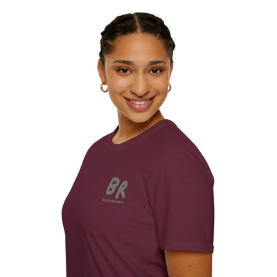 A woman smiling and looking over her shoulder, wearing a maroon Southern Heritage Shirt with the "BR Bluegrass Roots" logo visible