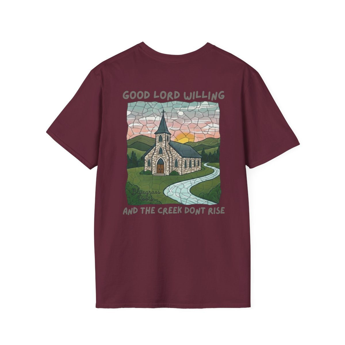 A maroon Southern Heritage Shirt displayed flat, showing the back design of a church and the phrase "Good Lord Willing and the creek don't rise"