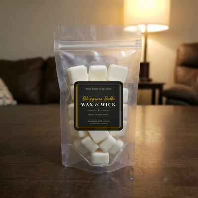 Clear stand-up pouch of rounded square wax melts with the Bluegrass Belle label