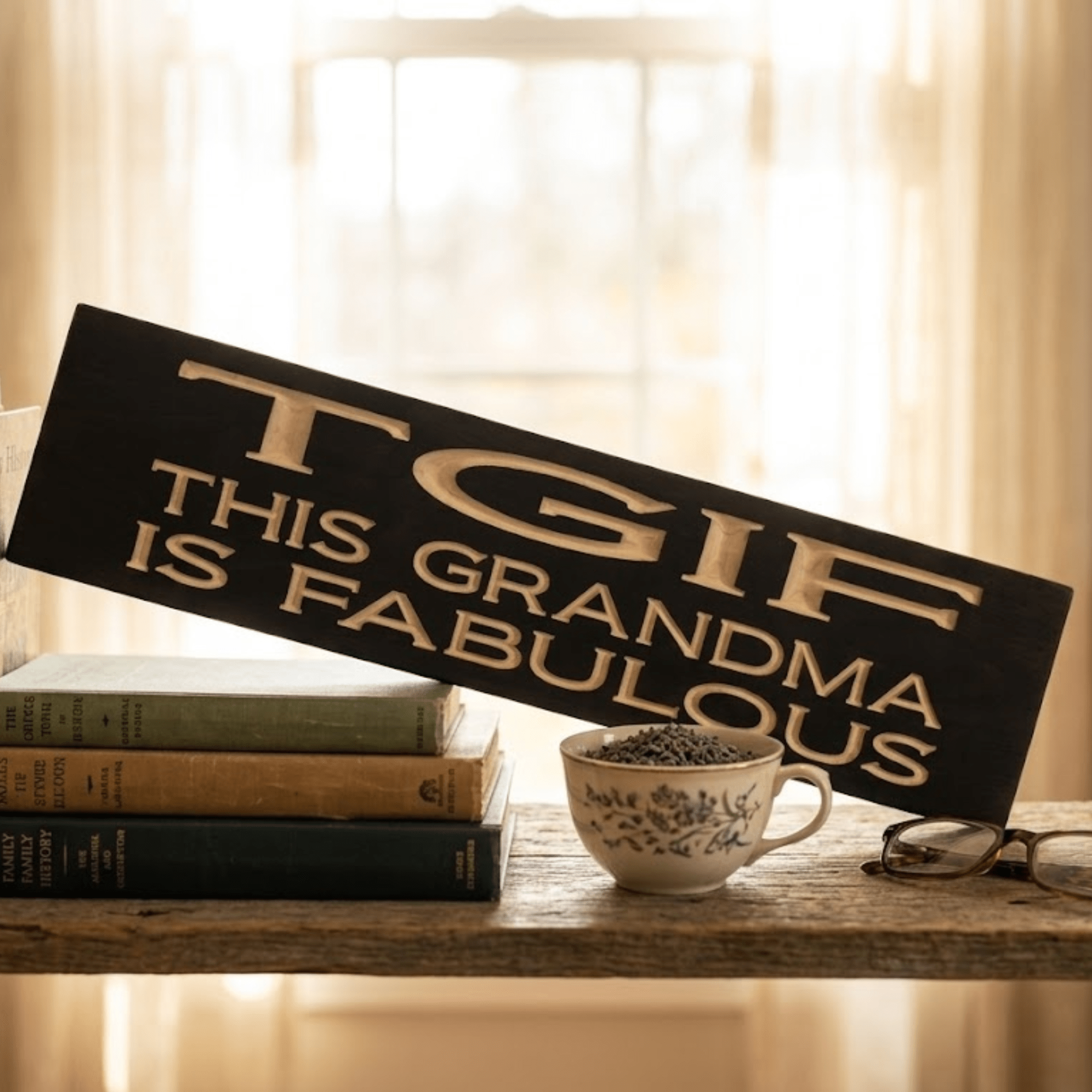 TGIF This Grandma Is Fabulous funny wood sign displayed on a rustic shelf with vintage books, teacup, and reading glasses in warm window light