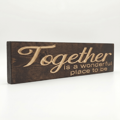 Angled side view of the Together is a Wonderful Place to Be carved wood sign showing the dimensional 2.5D depth of the routed letters in Dark Walnut