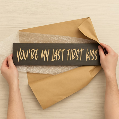 Unboxing the “You’re My Last First Kiss” wood sign with hanger installed—ready-to-gift romantic décor.