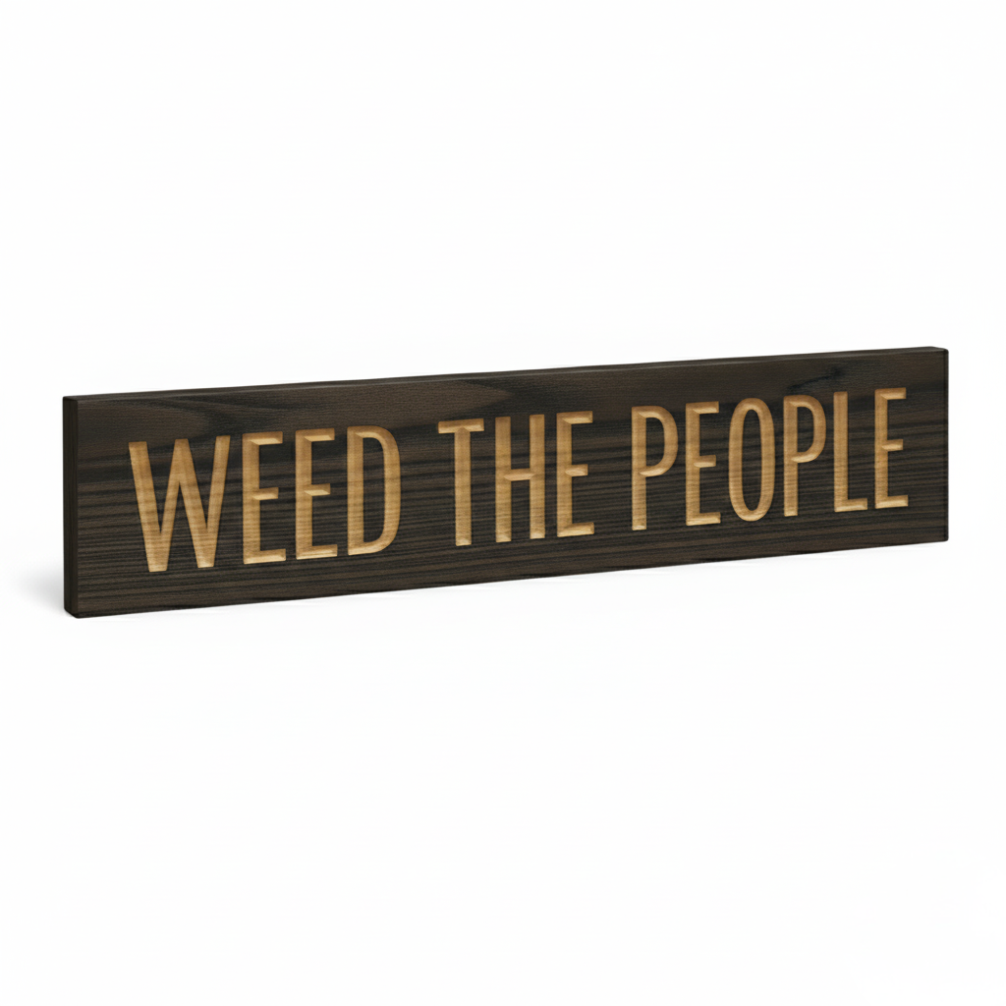 An angled perspective shot of the "Weed The People" wood sign with a dark finish, highlighting the depth of the CNC-carved letters and real wood grain.