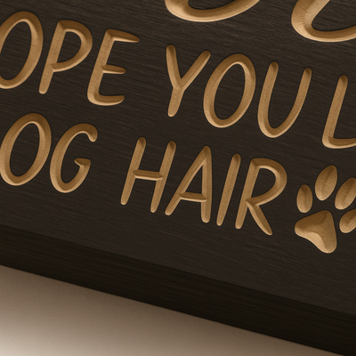 Close-up carved lettering detail of Welcome Hope You Like Dog Hair wooden sign