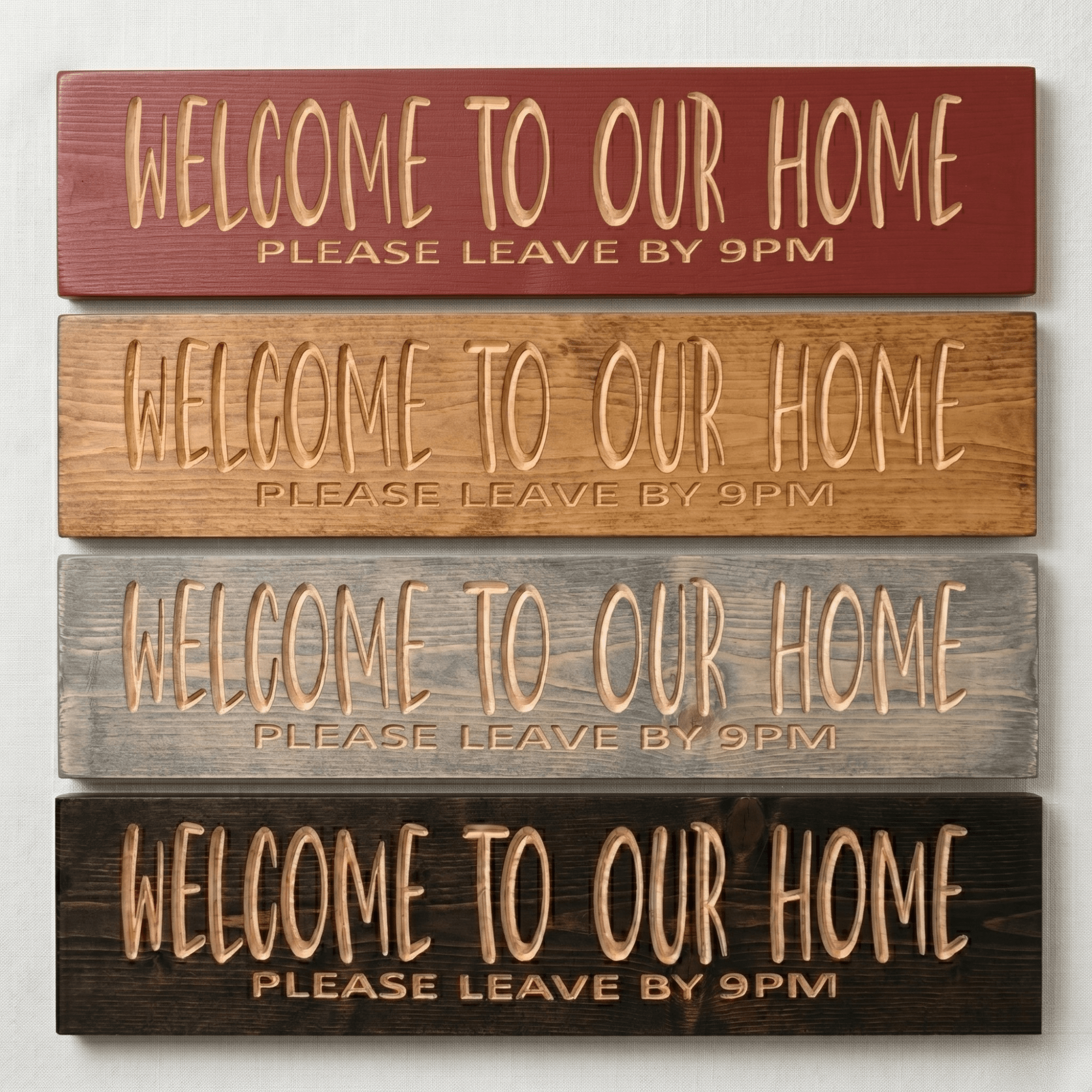 Four finish options for the Welcome to Our Home Please Leave by 9PM carved wood sign — barn red, natural pine, weathered gray, and dark walnut
