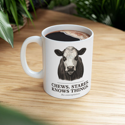 Cow Coffee Mug — "Chews. Stares. Knows Things." Vintage Engraved Black Baldy Mug