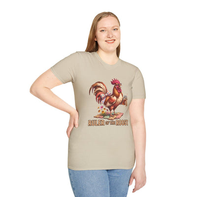 A woman standing, smiling, wearing a beige Rooster Shirt - Ruler of the Roost, with her hand on her hip