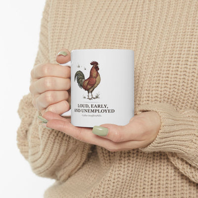 A person in a light-colored sweater holds the Rooster Coffee Mug with both hands, showing the rooster design clearly