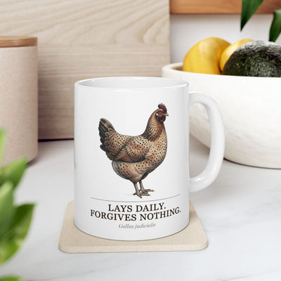 A white Chicken Coffee Mug resting on a light-colored coaster in a kitchen with fruit and plants in the background