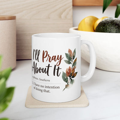 A Sarcastic Coffee Mug resting on a light-colored coaster in a kitchen setting with fruit and cutting boards visible