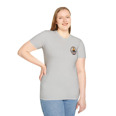 Front view of a woman in a gray Raised Right Shirt, standing with one hand on her hip, showing the small chest logo