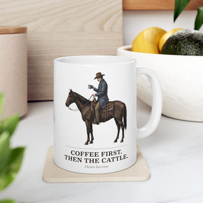 The white Cowboy Coffee Mug rests on a light coaster in a kitchen, surrounded by fresh fruit and greenery