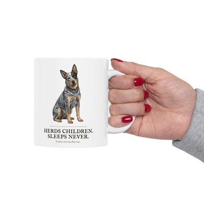 A hand with red painted nails holds the white Dog Mom Mug, featuring the dog graphic and humorous text prominently