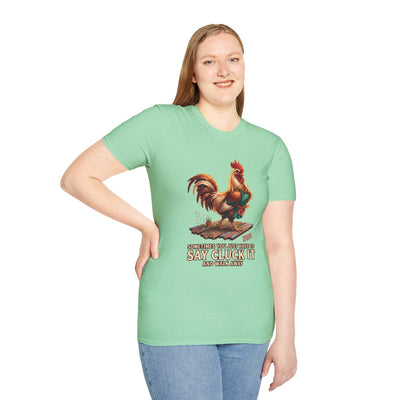 A woman standing with a hand on her hip, wearing a light green 'Chicken Shirt - Sometimes You Just Have to Say Cluck It' tee