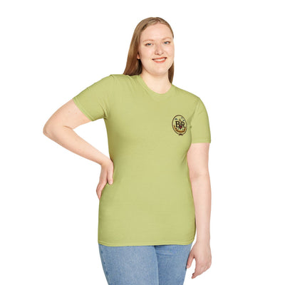 A smiling woman in a light green tee with a small chest logo, posing front-facing as she models our Cowgirl Shirts